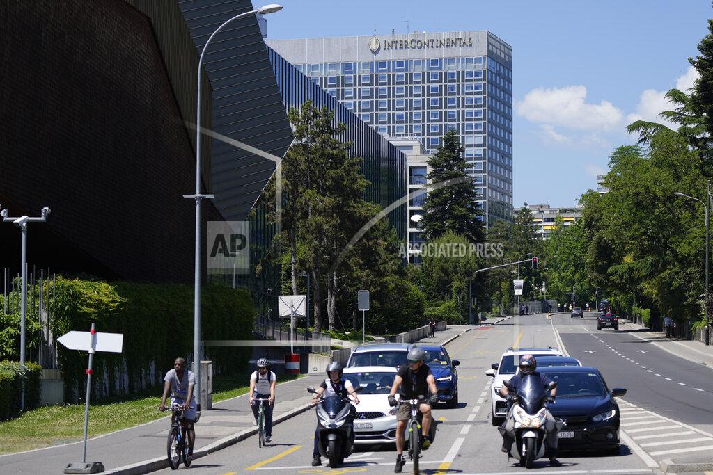Markus Schreiber Bikes and cars stand in front of a traffic light near the Hotel Intecontinental in Geneva, Switzerland Monday, June 14, 2021. US President Joe Biden will sleep in the hotel ahead of the meeting with Russian President Vladimir Putin, which is scheduled for Wednesday, June 16, 2021 in Geneva. (AP Photo/Markus Schreiber)