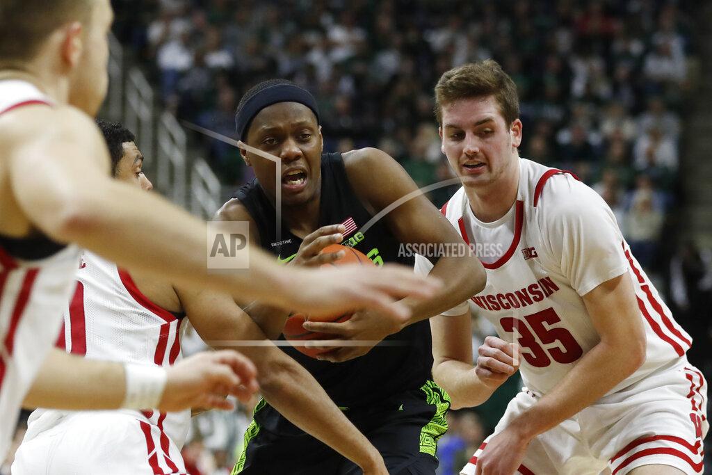 Carlos Osorio Michigan State guard Cassius Winston, center, cuts through the defense of Wisconsin guard D'Mitrik Trice (0) and forward Nate Reuvers (35) during the second half of an NCAA college basketball game, Friday, Jan. 17, 2020, in East Lansing, Mich. (AP Photo/Carlos Osorio)