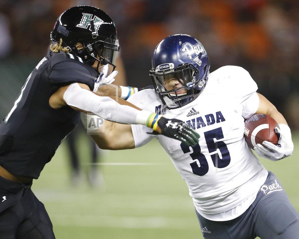 Marco Garcia Nevada running back Toa Taua (35) tries to shove off Hawaii defensive back Jay Dominique (11) during the third quarter of an NCAA college football game Saturday, Oct. 20, 2018, in Honolulu. (AP Photo/Marco Garcia)