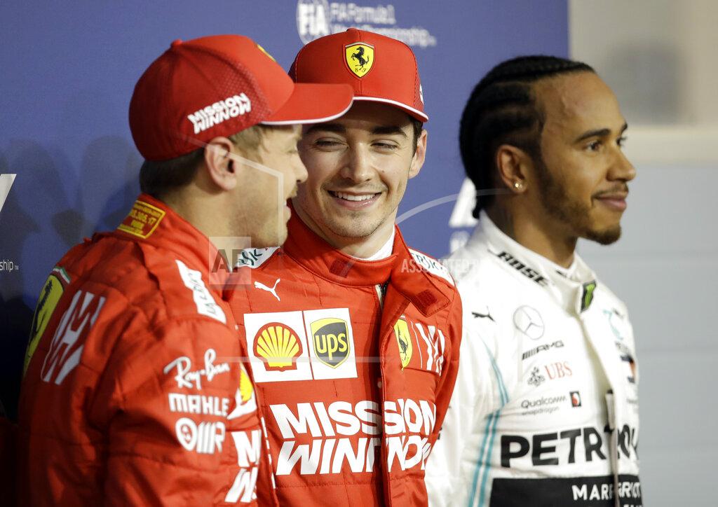Luca Bruno Ferrari driver Charles Leclerc of Monaco, center, celebrates his pole position with runner up Ferrari driver Sebastian Vettel of Germany, left and Mercedes driver Lewis Hamilton of Britain after the qualifying session at the Formula One Bahrain International Circuit in Sakhir, Bahrain, Saturday, March 30, 2019. The Bahrain Formula One Grand Prix will take place on Sunday. (AP Photo/Luca Bruno)