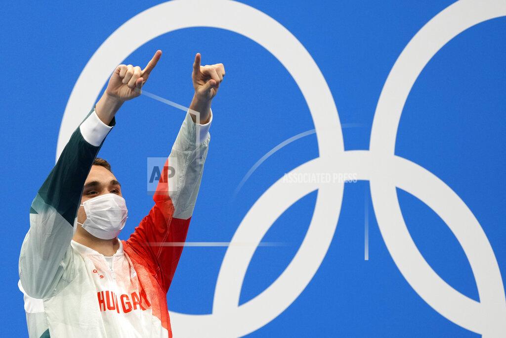 Martin Meissner Kristof Milak of Hungary waves on the podium after winning the gold medal in the men's 200-meter butterfly final at the 2020 Summer Olympics, Wednesday, July 28, 2021, in Tokyo, Japan. (AP Photo/Martin Meissner)