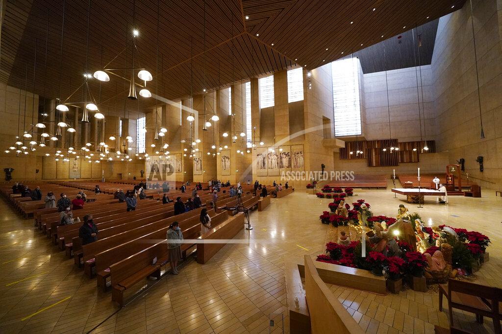 Ashley Landis Worshipers gather for Christmas Eve Mass inside the Cathedral of Our Lady of the Angels Thursday, Dec 24, 2020, in Los Angeles. California became the first state to record 2 million confirmed coronavirus cases, reaching the milestone on Christmas Eve as nearly the entire state was under a strict stay-at-home order and hospitals were flooded with the largest crush of cases since the pandemic began. (AP Photo/Ashley Landis)