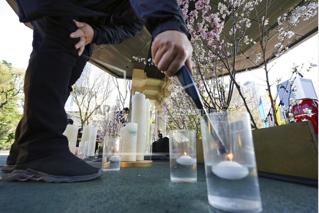 Eugene Hoshiko A staff member prepares the decoration to mourn for the victims of the 2011 earthquake and tsunami prior to an online special memorial event at Hibiya Park in Tokyo Thursday, March 11, 2021. Japan on Thursday marked the 10th anniversary of the massive earthquake, tsunami and nuclear disaster that struck Japan's northeastern coast. (AP Photo/Eugene Hoshiko)