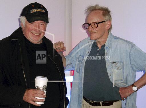 This May 2008 photo provided by Libby Lumpkin shows Dave Hickey, left with Peter Schjeldahl. Hickey, a prominent American critic whose essays covered topics ranging from Liberace to Norman Rockwell, has died. The brash style and mixing of high- and low-brow culture that characterized his work earned him legions of fans and leaves leave a lasting influence on a generation of artists and critics. He died Nov. 12, 2021, at home in Santa Fe, New M.M., after years of heart disease, his art historian wife Libby Lumpkin said. (Libby Lumpkin via AP)