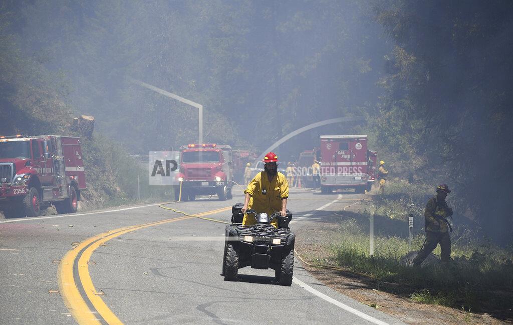 Elias Funez Area firefighters utilize an all terrain vehicle to help fight the Golden Fire in Camptonville, Calif. Friday, May 20, 202. (Elias Funez/The Union via AP)