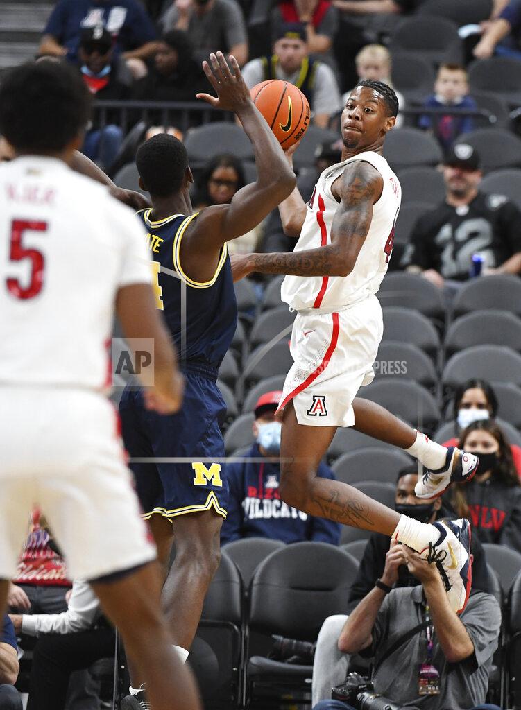 Sam Morris Arizona guard Dalen Terry (4) leaps to keep a ball inbounds during an NCAA college basketball game against Michigan Sunday, Nov. 21, 2021, in Las Vegas. (AP Photo/Sam Morris)