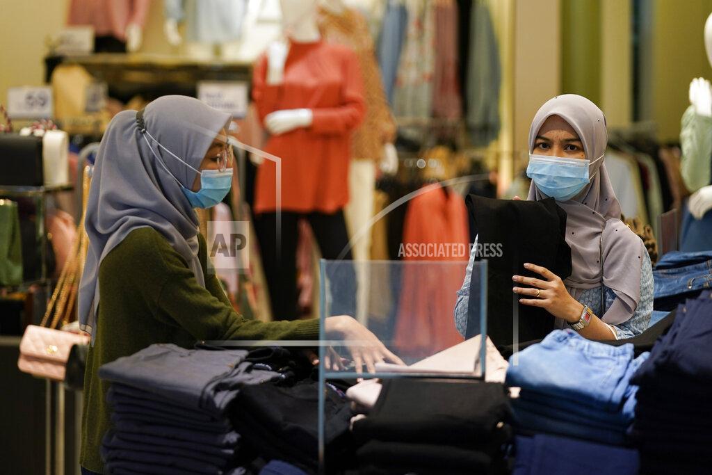 Vincent Thian Shoppers wearing a face mask to help curb the spread of the coronavirus shopping at mall in Putrajaya, Malaysia, Monday, Oct. 5, 2020. Prime Minister Muhyiddin Yassin says he will self-quarantine after a Cabinet minister he was in contact with tested positive for the coronavirus. (AP Photo/Vincent Thian)