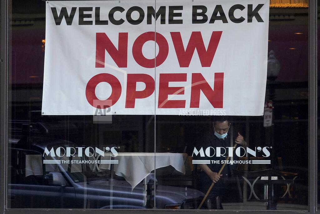 Jeff Chiu FILE - In this March 4, 2021, file photo, a sign reading "Welcome Back Now Open" is posted on the window of a Morton's Steakhouse restaurant as a man works inside during the coronavirus pandemic in San Francisco. State governments will get a big influx of federal money from the $1.9 trillion COVID-19 relief package that could suddenly enable them to undertake large, expensive projects that have long been on their to-do lists, including high-speed internet for rural areas and drinking water improvements. (AP Photo/Jeff Chiu, File)