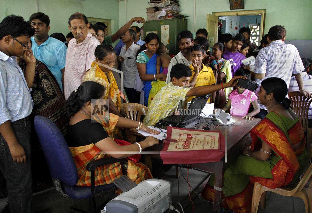 Bikas Das In this Wednesday, May 16, 2012, file photo, Indians crowd a room as they wait to enroll for Aadhar, India's unique identification project in Kolkata, India. A U.S.-based private cybersecurity company said Wednesday, Sept. 22, 2021, it has uncovered evidence that an Indian media conglomerate, a police department and the agency responsible for the country's national identification database have been hacked, likely by a state-sponsored Chinese group. (AP Photo/Bikas Das, File)
