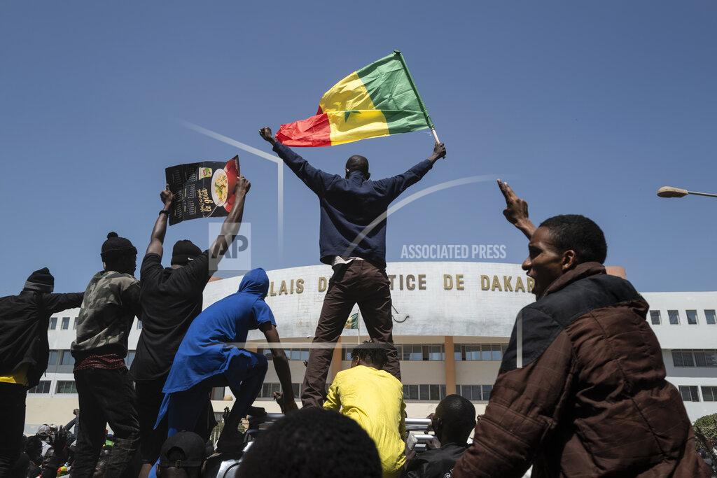 Sylvain Cherkaoui Demonstrators shout slogans during a protest against the arrest of opposition leader and former presidential candidate Ousmane Sonko near the Justice Palace of Dakar, Senegal, Monday, March 8, 2021. A Senegalese court cleared the way Monday for Sonko's release pending his rape trial in a case that already has sparked deadly protests and threatened to erode the country's reputation as one of West Africa's most stable democracies. (AP Photo/Sylvain Cherkaoui)