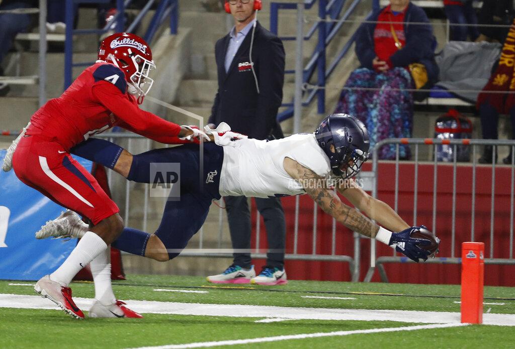 Gary Kazanjian Nevada wide receiver Elijah Cooks dives in for a touchdown as Fresno State defensive back Wylan Free tries to stop Cooks before the line during the first half of an NCAA college football game in Fresno, Calif., Saturday, Nov. 23, 2019. (AP Photo/Gary Kazanjian)