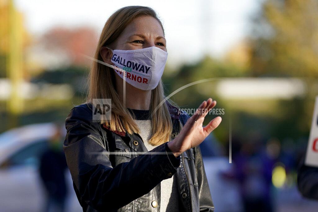 Jeff Roberson Missouri Auditor and Democratic gubernatorial candidate Nicole Galloway waves to voters as they stand in line outside a polling place Tuesday, Nov. 3, 2020, in St. Louis. Galloway is challenging incumbent Republican Gov. Mike Parson. (AP Photo/Jeff Roberson)