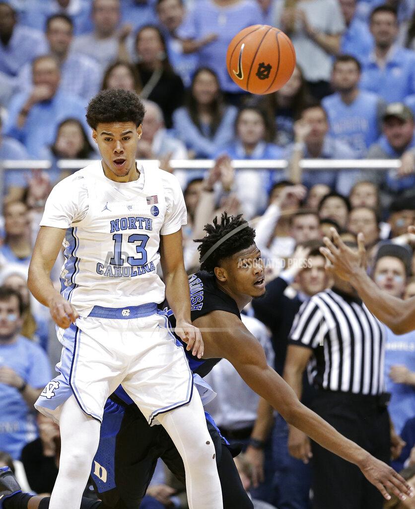 Gerry Broome North Carolina's Cameron Johnson (13) and Duke's Cam Reddish struggle for the ball during the second half of an NCAA college basketball game in Chapel Hill, N.C., Saturday, March 9, 2019. North Carolina won 79-70. (AP Photo/Gerry Broome)