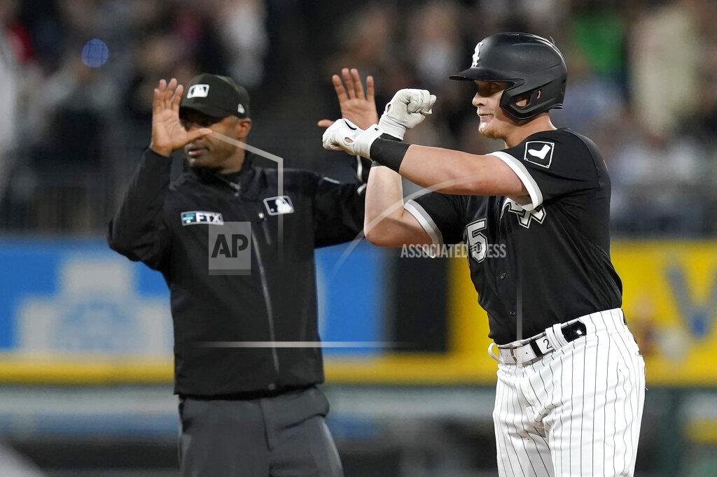 Charles Rex Arbogast Chicago White Sox's Andrew Vaughn celebrates his three-run double off Boston Red Sox starting pitcher Michael Wacha as second base umpire Alan Porter calls time during the third inning of a baseball game Thursday, May 26, 2022, in Chicago. (AP Photo/Charles Rex Arbogast)