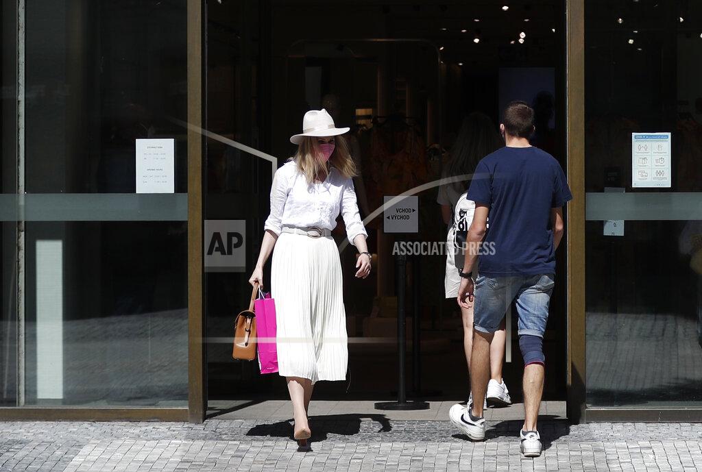 Petr David Josek A woman walks out of a shop in Prague, Czech Republic, Monday, May 10, 2021. The Czech Republic is massively relaxing its coronavirus restrictions as the hard-hit nation pay respect to nearly 30,000 dead. Monday's wave of easing came after the new infections fell to the levels unseen from August when the government failed to react in time to an opposite trend, the growing numbers of infected which later contributed to record numbers of deaths. (AP Photo/Petr David Josek)