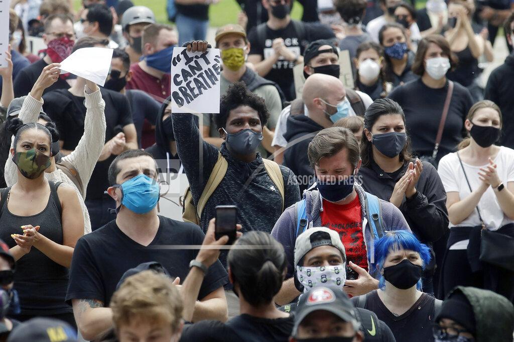 Jeff Chiu A man holds up a sign while listening to speakers at a protest over the Memorial Day death of George Floyd, a handcuffed black man in police custody in Minneapolis, in San Francisco, Saturday, May 30, 2020. (AP Photo/Jeff Chiu)