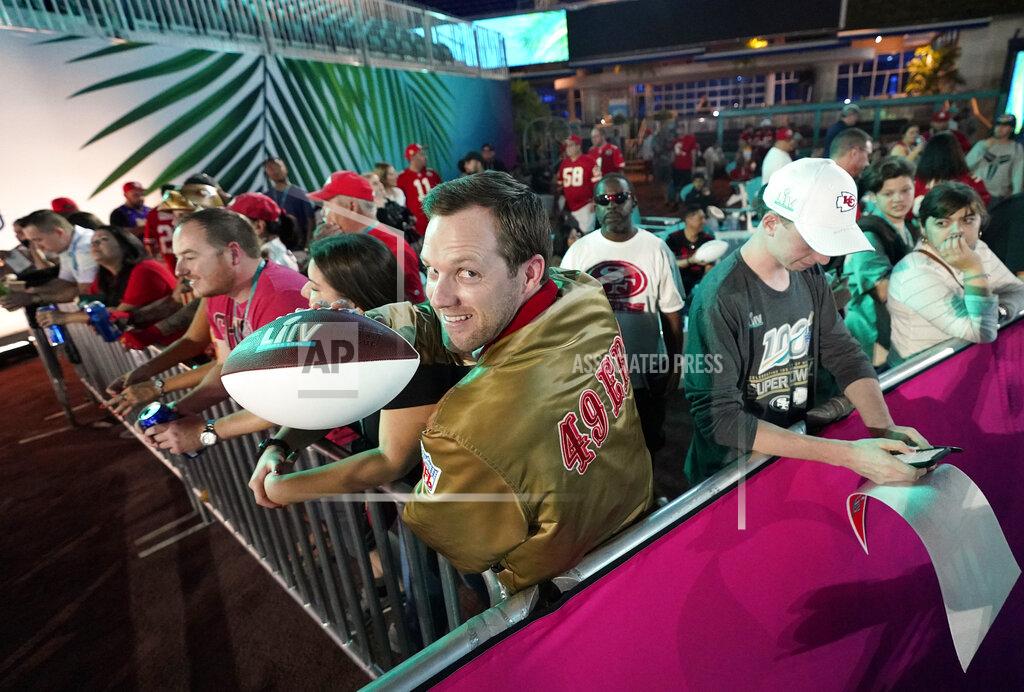 David J. Phillip San Francisco 49ers fans wait for Opening Night for the NFL Super Bowl 54 football game Monday, Jan. 27, 2020, at Marlins Park in Miami. (AP Photo/David J. Phillip)