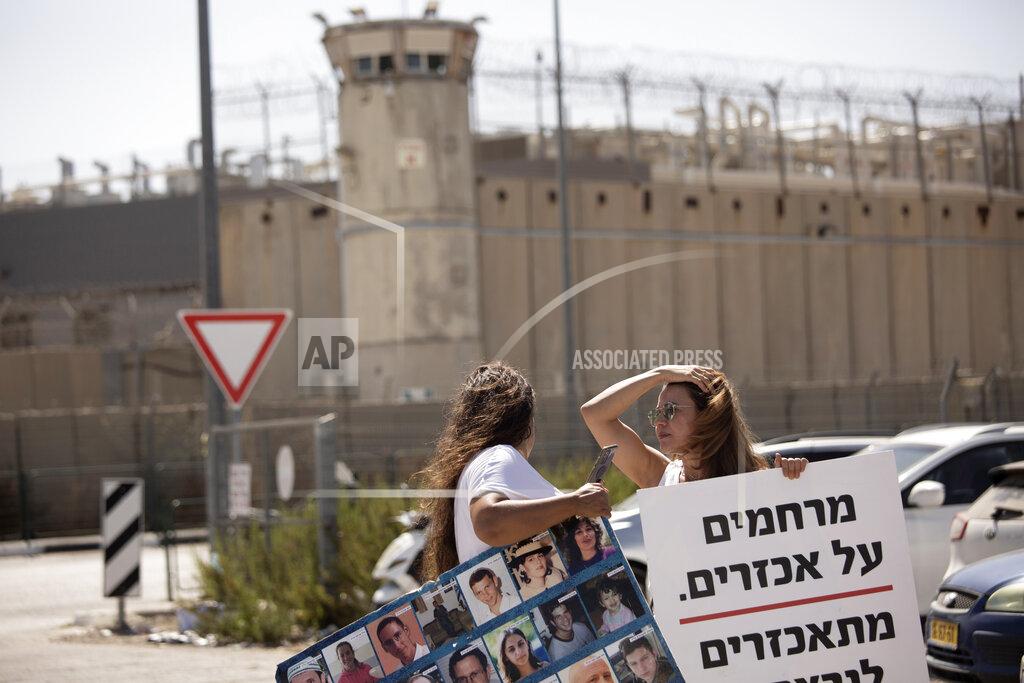 Maya Alleruzzo Members of the group Choosing Life, that includes relatives of Israelis killed in Palestinian attacks, protest outside of Ofer Prison near Jerusalem, Thursday, Sept. 9, 2021, after the escape of six Palestinian prisoners from Gilboa prison on Monday. At left is a poster depicting slain Israelis; at right is a poster that reads: "compassion for the cruel is cruel to the murdered." (AP Photo/Maya Alleruzzo)
