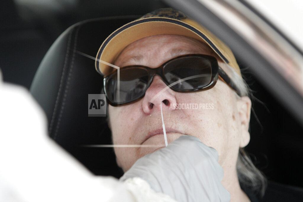 Nati Harnik FILE - In this April 24, 2020 file photo, a resident undergoes a polymerase chain reaction (PCR) test to detect the presence of COVID-19 at a testing site affiliated with the Methodist Health System, in Omaha, Neb. On Friday, July 30, 2021 The Associated Press reported on stories circulating online that misrepresented a move by the Centers for Disease Control and Prevention to phase out an early PCR coronavirus test.(AP Photo/Nati Harnik, File)