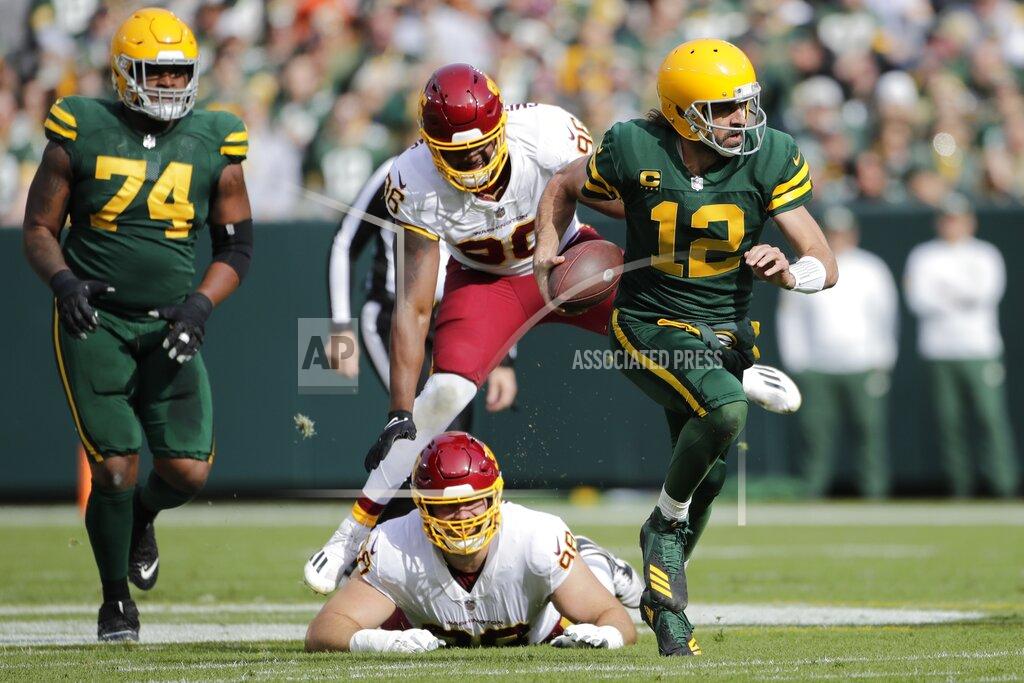 Aaron Gash Green Bay Packers' Aaron Rodgers runs for a first down during the first half of an NFL football game against the Washington Football Team Sunday, Oct. 24, 2021, in Green Bay, Wis. (AP Photo/Aaron Gash)