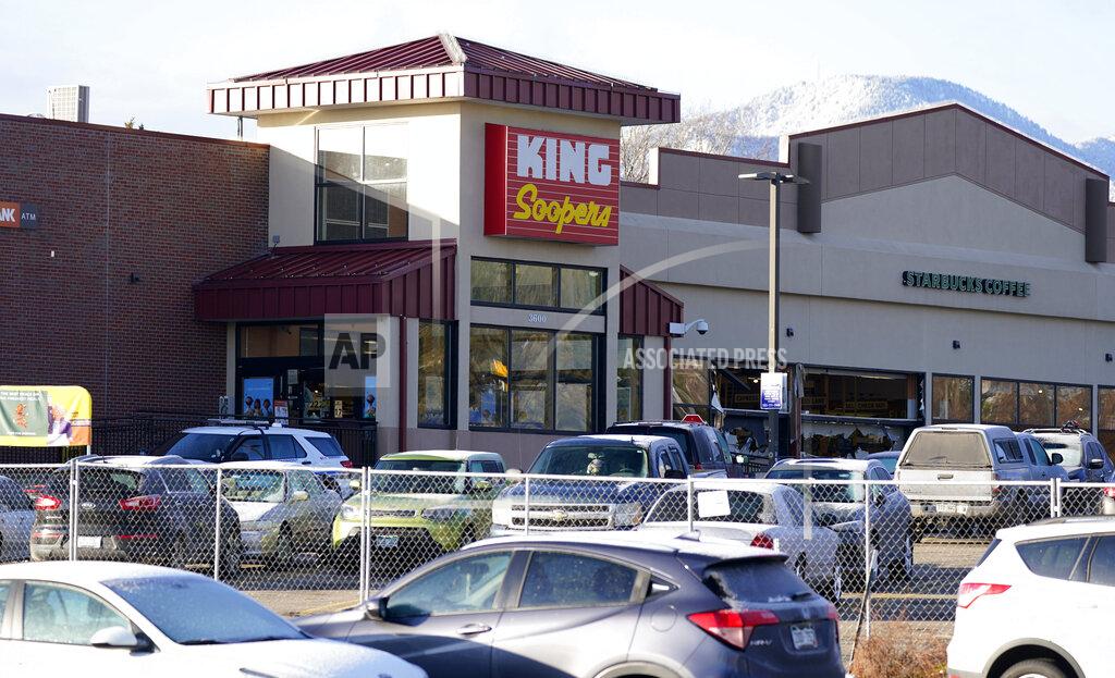 David Zalubowski In this March 23, 2021, photo, a makeshift fence stands around the parking lot outside a King Soopers grocery store where a mass shooting took place in Boulder, Colo. The suspects in the most recent shooting sprees found it relatively easy to get their guns. The suspect in the shooting at a Boulder supermarket was convicted of assaulting a high school classmate but still got a gun. (AP Photo/David Zalubowski)