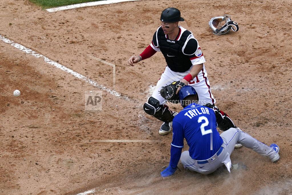Nam Y. Huh Kansas City Royals' Michael A. Taylor (2) scores on a throwing error by Chicago White Sox relief pitcher Garrett Crochet as catcher Zack Collins, top, watches the ball during the 10th inning of a baseball game in Chicago, Sunday, April 11, 2021. (AP Photo/Nam Y. Huh)