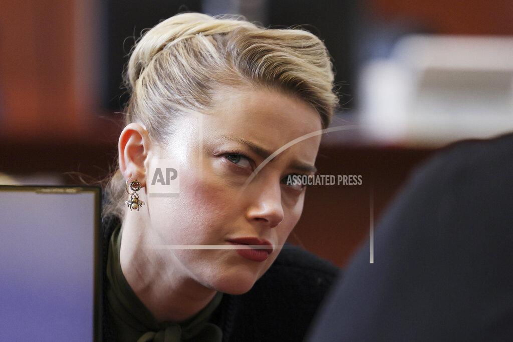 Evelyn Hockstein Actor Amber Heard speaks with a legal team member at the Fairfax County Circuit Courthouse in Fairfax, Va., Wednesday, May 25, 2022. Actor Johnny Depp sued his ex-wife Amber Heard for libel in Fairfax County Circuit Court after she wrote an op-ed piece in The Washington Post in 2018 referring to herself as a "public figure representing domestic abuse." (Evelyn Hockstein/Pool photo via AP)