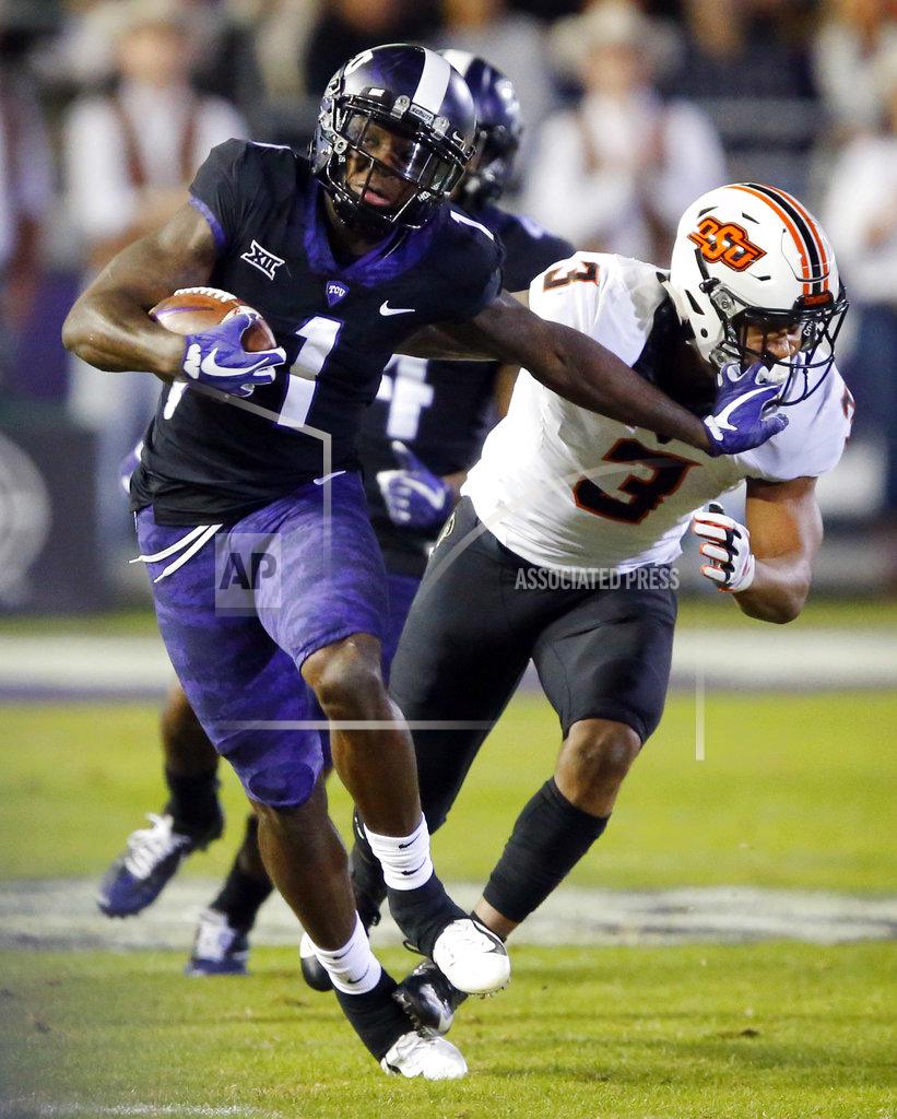 Tom Fox TCU wide receiver Jalen Reagor (1) gives Oklahoma State linebacker Kenneth Edison-McGruder (3) a stiff-arm after making a catch during the first quarter of an NCAA college football game in Fort Worth, Texas, Saturday, Nov. 24, 2018. (Tom Fox/The Dallas Morning News via AP)