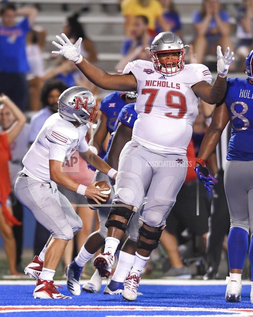 Reed Hoffmann FILE - In this Sept. 1, 2018, file photo, Nicholls State quarterback Chase Fourcade, left, celebrates his touchdown in overtime against Kansas with offensive lineman P.J. Burkhalter (79), during an NCAA college football game, in Lawrence, Kan. Burkhalter is a member of The Associated Press FCS All-America team, announced Wednesday, May 12, 2021. (AP Photo/Reed Hoffmann, File)