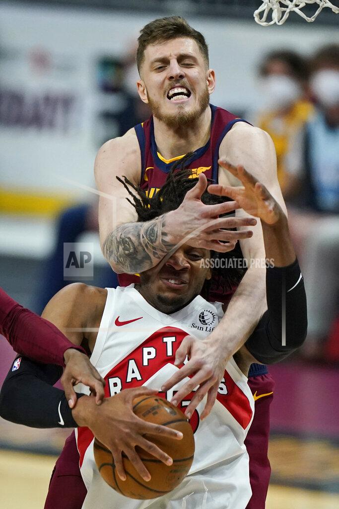 Tony Dejak Cleveland Cavaliers Isaiah Hartenstein, top, knocks the ball loose from Toronto Raptors' Freddie Gillespie in the first half of an NBA basketball game, Saturday, April 10, 2021, in Cleveland. (AP Photo/Tony Dejak)