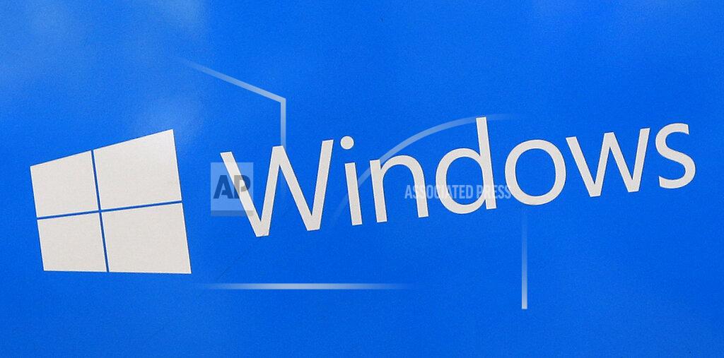 FILE - This Aug. 7, 2017, file shows a Microsoft Widows sign on display at a store in Hialeah, Fla. The National Security Agency has discovered a major security flaw in Microsoft's Windows operating system. Microsoft says the NSA notified the company about it. A fix was made available Tuesday, Jan. 14, 2020. (AP Photo/Alan Diaz)