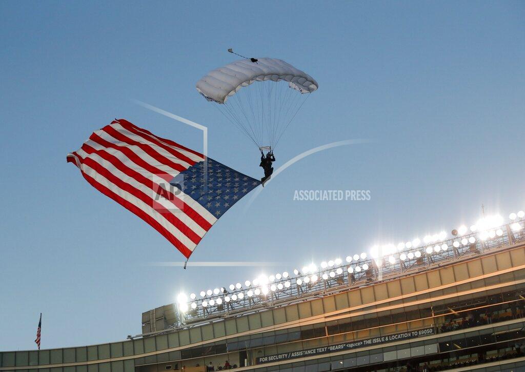 Charles Rex Arbogast A member of the U.S. Air Force parachutes into Soldier Field before an NFL football game between the Green Bay Packers and the Chicago Bears Thursday, Sept. 5, 2019, in Chicago. (AP Photo/Charles Rex Arbogast)