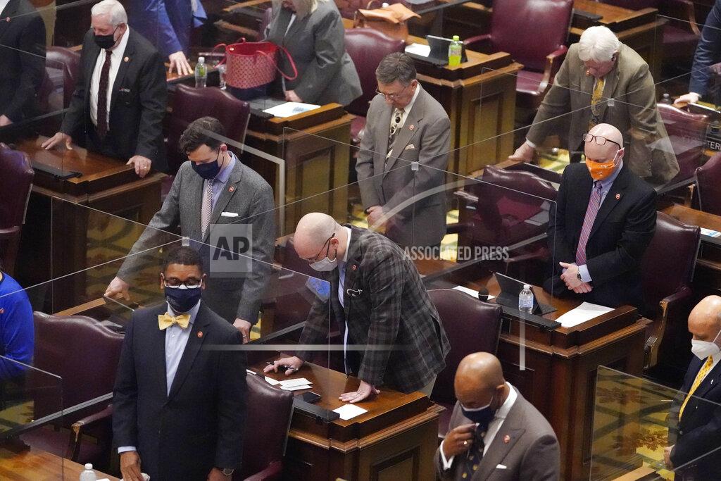 Members of the House of Representatives pause for a moment of silence for teachers who have died due to COVID-19 during a special session on education Thursday, Jan. 21, 2021, in Nashville, Tenn. (AP Photo/Mark Humphrey)