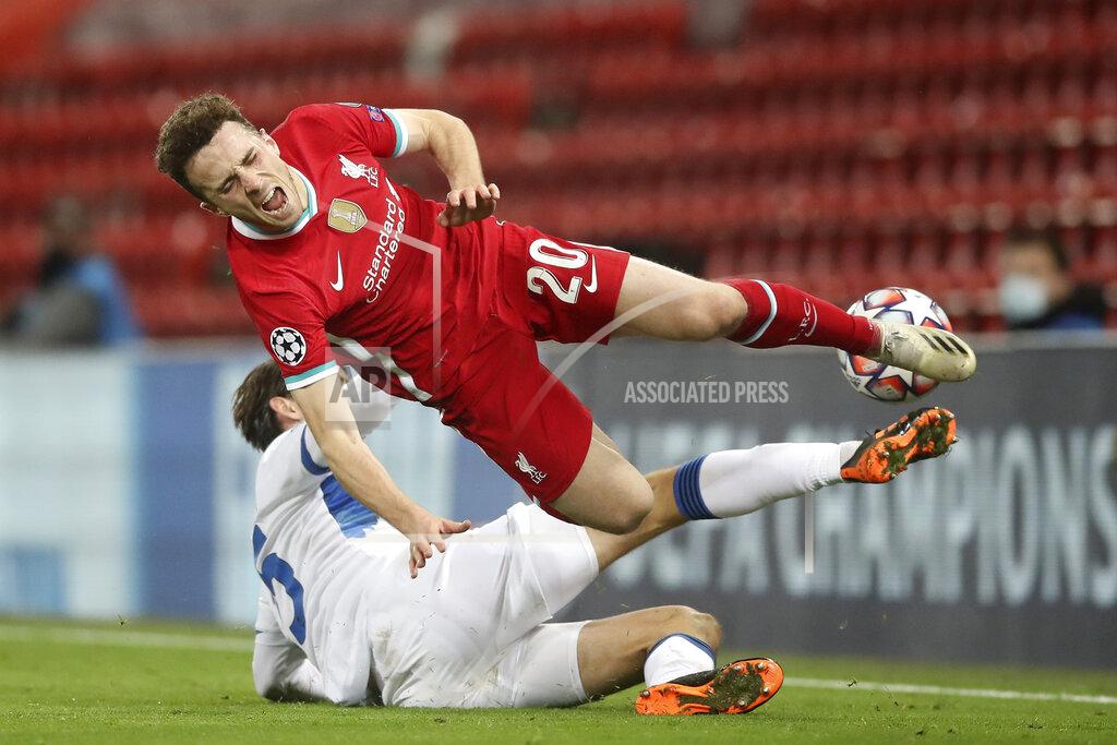 Martin Rickett Atalanta's Marten de Roon, background, tackles Liverpool's Diogo Jota during the Champions League group D soccer match between Liverpool and Atalanta at Anfield stadium in Liverpool, England, Wednesday, Nov. 25, 2020. (Martin Rickett/Pool via AP)