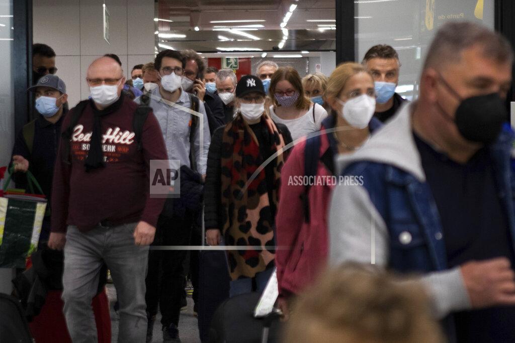 Francisco Ubilla Passengers wearing face masks arrive at Palma de Mallorca Airport on the Spanish Balearic Island of Mallorca, Spain, Saturday, March 27, 2021. Efforts in Spain to restart tourism activity is drawing a mixed picture due to a patchwork of national, regional and European rules on travel that is confusing both tourists and their hosts. (AP Photo/Francisco Ubilla)