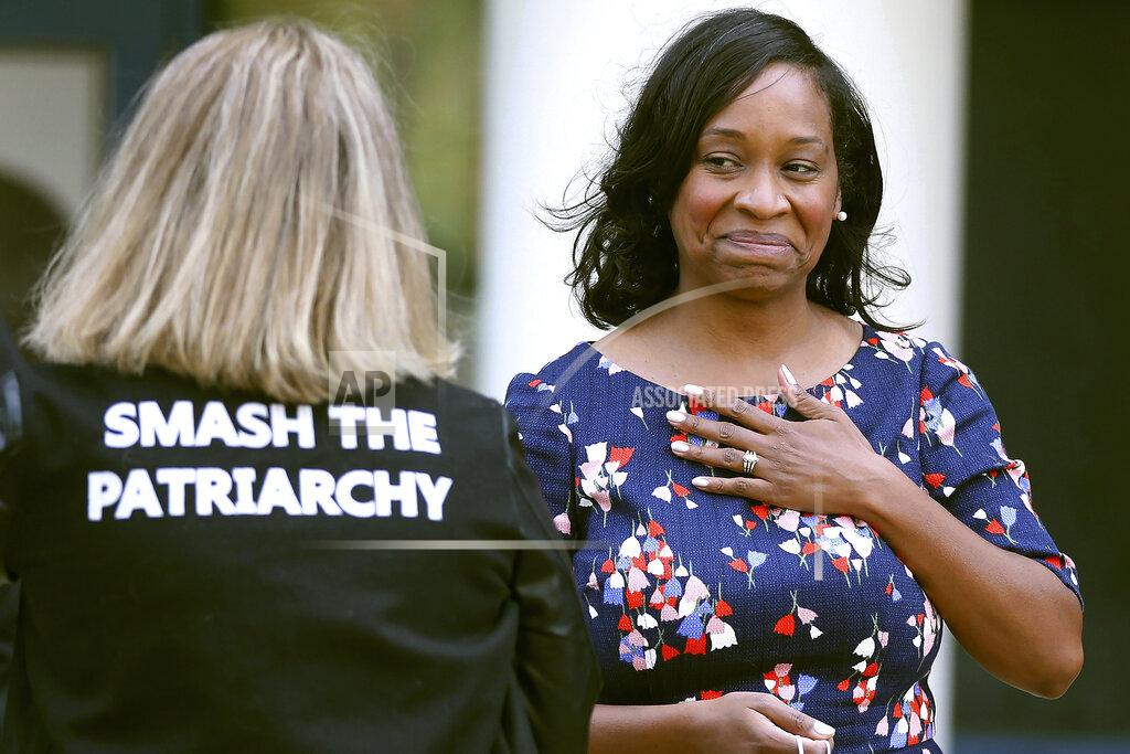 Nancy Lane In this Sept. 24, 2020 photo, Andrea Campbell, right, speaks with campaign worker Katie Priosco-Buxbaum, left, after Campbell announced that she is a candidate for mayor of Boston in the fall 2021 election. (Nancy Lane/Boston Herald via AP)