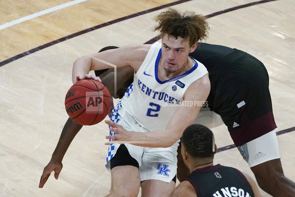 Rogelio V. Solis Kentucky guard Devin Askew (2) keeps the ball in play as a Mississippi State defender attempts to steal it during the second half of an NCAA college basketball game in Starkville, Miss., Saturday, Jan. 2, 2021. (AP Photo/Rogelio V. Solis)