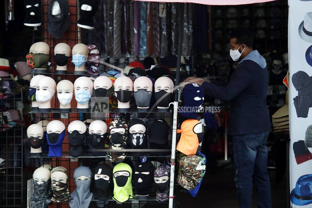 Marcio Jose Sanchez FILE - In this Friday, March 20, 2020, file photo, a merchant displays masks for sale in Los Angeles. Retail analysts expect mask sales will get another jolt after the Centers for Disease Control and Prevention late Tuesday, July 27, 2021, changed course on some masking guidelines, recommending that even vaccinated people return to wearing masks indoors in parts of the U.S. where cases of the coronavirus are surging. (AP Photo/Marcio Jose Sanchez, File)