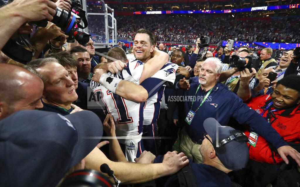 In this Sunday, Feb. 3, 2019, photo New England Patriots' Julian Edelman and Tom Brady celebrate after the NFL Super Bowl 53 football game against the Los Angeles Rams in Atlanta. The Patriots won 13-3. Edelman was named the Most Valuable Player. (Curtis Compton/Atlanta Journal-Constitution via AP)