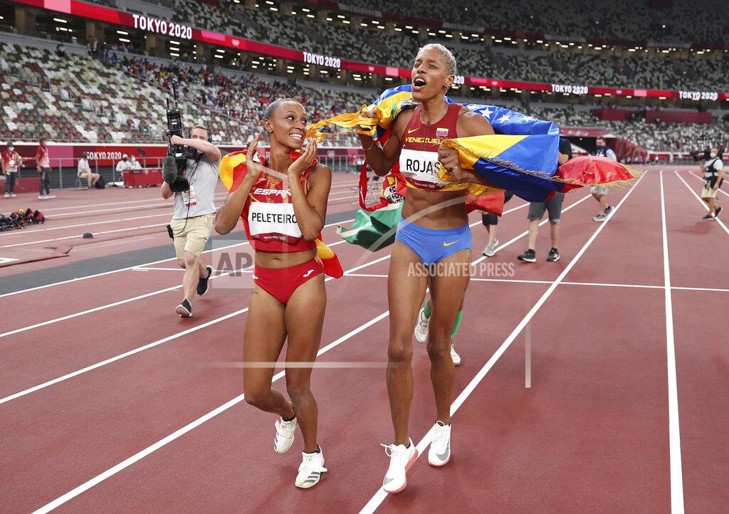 Christian Petersen Gold medalist Yulimar Rojas of Venezuela, right, and bronze medalist Ana Peleteiro of Spain, celebrate on the track following the final of the women's triple jump at the 2020 Summer Olympics, Sunday, Aug. 1, 2021, in Tokyo, Japan. (Christian Petersen/Pool Photo via AP)