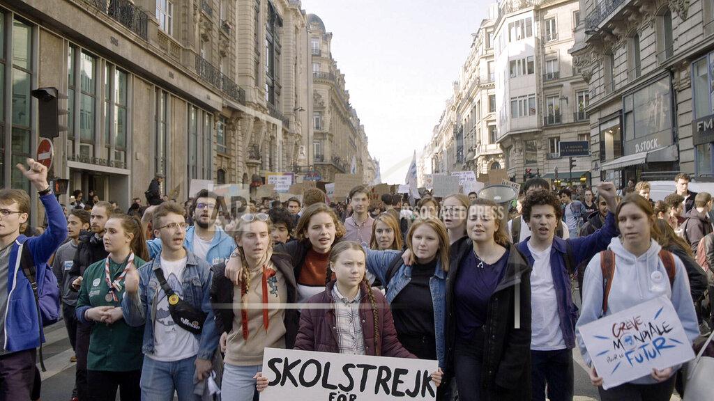 Uncredited This image released by Hulu shows activist Greta Thunberg, center, in a scene from the documentary "I Am Greta" the story of Thunberg, the teenage Swedish schoolgirl who is leading the global school strike for action on climate change. The film premieres Friday on Hulu. (Hulu via AP)