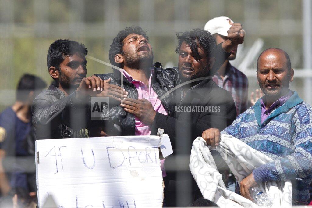 Petros Giannakouris FILE - In this Tuesday, April 5, 2016 file photo, refugees and migrants most of them from Pakistan, protest against the EU-Turkey deal about migration inside the entrance of Moria camp in the Greek island of Lesbos. Five years on, the deal between European Union and Turkey is no longer working but at a summit next week EU leaders will discuss ways to improve relations with Turkey and could try to revive the agreement. (AP Photo/Petros Giannakouris, File)