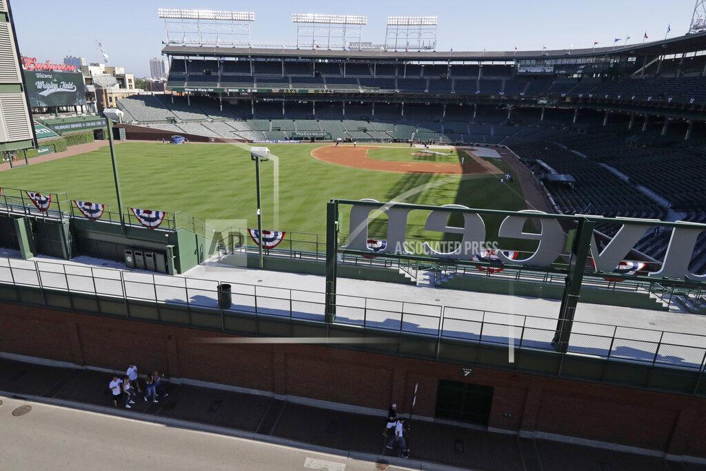 Nam Y. Huh Wrigley Field is viewed from a nearby rooftop before an opening day baseball game between the Chicago Cubs and the Milwaukee Brewers in Chicago, Friday, July 24, 2020, in Chicago. For fans looking to see major league baseball live during the coronavirus pandemic, there are few options besides the rooftops along Waveland and Sheffield Avenues. (AP Photo/Nam Y. Huh)