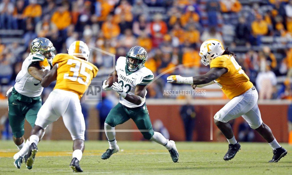 Wade Payne Charlotte running back Benny LeMay (32) runs for yardage as he's chased by Tennessee linebacker Jonathan Kongbo (99) in the second half of an NCAA college football game Saturday, Nov. 3, 2018, in Knoxville, Tenn. Tennessee won 14-3. (AP Photo/Wade Payne)