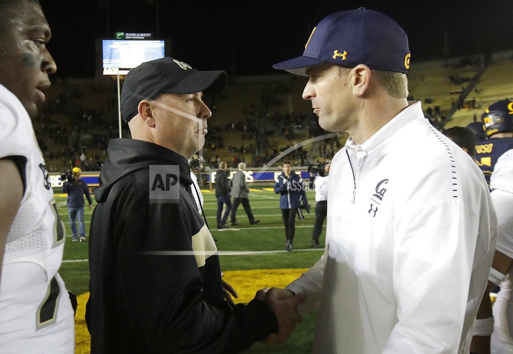 Jeff Chiu Colorado interim head coach Kurt Roper, left, shakes hands with California head coach Justin Wilcox after an NCAA college football game in Berkeley, Calif., Saturday, Nov. 24, 2018. California won, 33-21. (AP Photo/Jeff Chiu)
