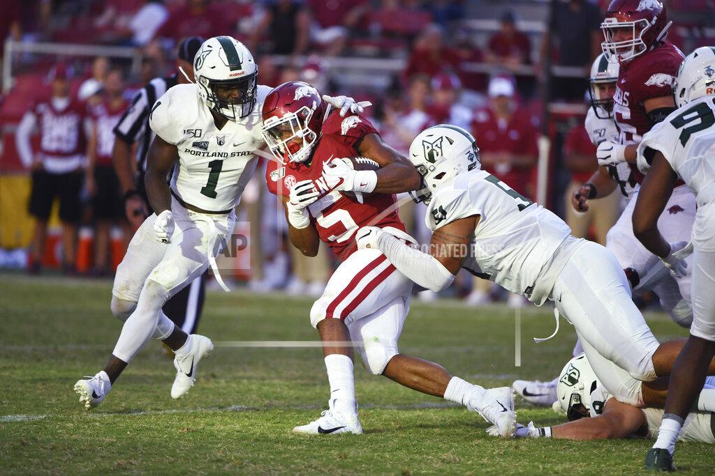 Michael Woods Arkansas running back Rakeem Boyd (5) is taken down by Portland State defenders Romeo Gunt (1) and Kenton Bartlett (51) during the second half of an NCAA college football game Saturday, Aug. 31, 2019 in Fayetteville, Ark. (AP Photo/Michael Woods)