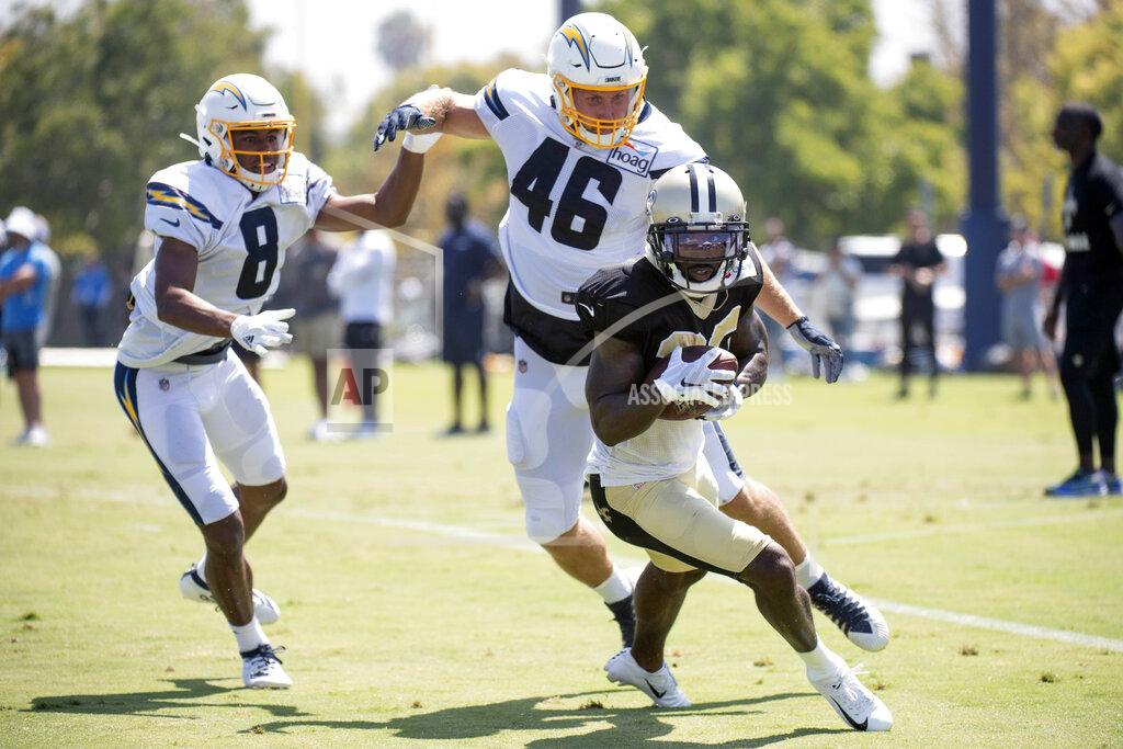 Kyusung Gong Los Angeles Chargers wide receiver Malachi Dupre (8) and tight end Matt Sokol (46) chase New Orleans Saints cornerback Ken Crawley after Crawley intercepted a pass intended for Dupre during a joint NFL football practice in Costa Mesa, Calif., Thursday, Aug. 15, 2019. (AP Photo/Kyusung Gong)