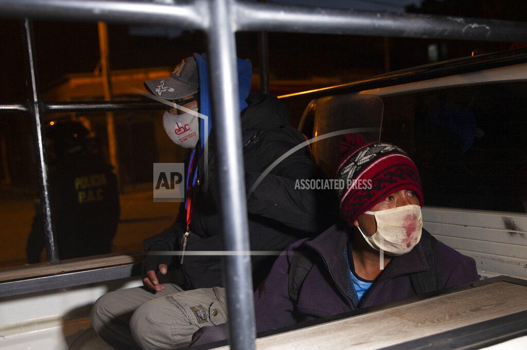 Juan Karita Detained demonstrators sit in the bed pf a police pick-up truck during a protest against the postponement of the upcoming presidential election in El Alto, Bolivia, Monday, Aug. 10, 2020. Citing the ongoing new coronavirus pandemic, the nation's highest electoral authority delayed presidential elections from Sept. 6 to Oct. 18, the third time the vote has been delayed. (AP Photo/Juan Karita)