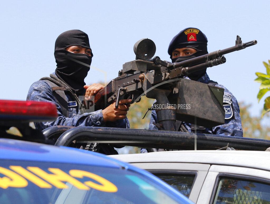Armed Guatemalan soldiers guard the integrated border crossing point of Corinto on the border with Honduras as groups of Honduran migrants are expected to arrive, in Guatemala, Tuesday, March 30, 2021. Hundreds of Honduran migrants started to move towards the Guatemalan border with the hope of making it to the U.S., even as local authorities worked to prevent them from doing so. (AP Photo/Delmer Martinez)
