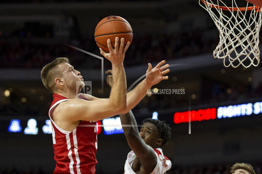 John Peterson Wisconsin guard Brad Davison (34) makes a lay up against Nebraska forward Kevin Cross (1) during the first half of an NCAA college basketball game in Lincoln, Neb., Saturday, Feb. 15, 2020. (AP Photo/John Peterson)